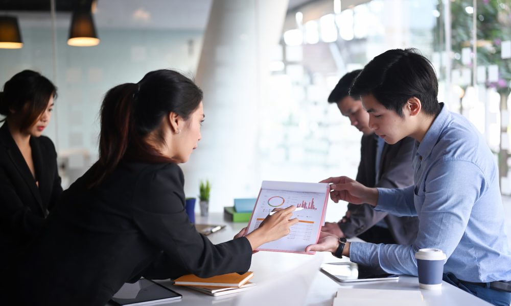 business-people-analyzing-documents-and-discussing-business-strategy-at-conference-room-.jpg